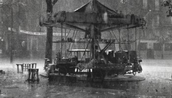 Robert Doisneau, Le Manège de Monsieur Barré, 1955. Carrousel, merry go round, amusement ride, rainy weather, urban landscape, 1950s